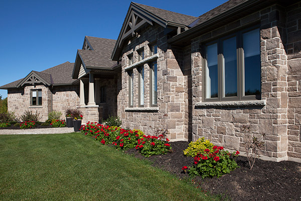 Bungalow finished on the outside with a beige stone.