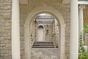 Shouldice Designer Stone - Arch and door with Roman surrounds