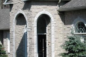 Shouldice Designer Stone - Arches and door with Roman surround