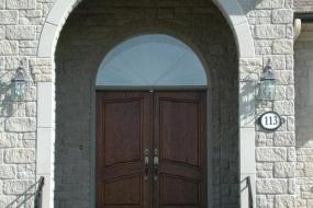 Shouldice Designer Stone - Arch and door with Roman surround