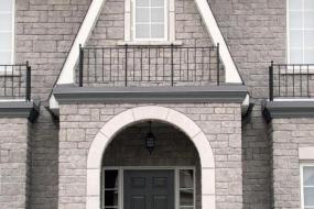 Shouldice Designer Stone - Arch and window with Roman surrounds