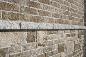 Sill separating brick and stone