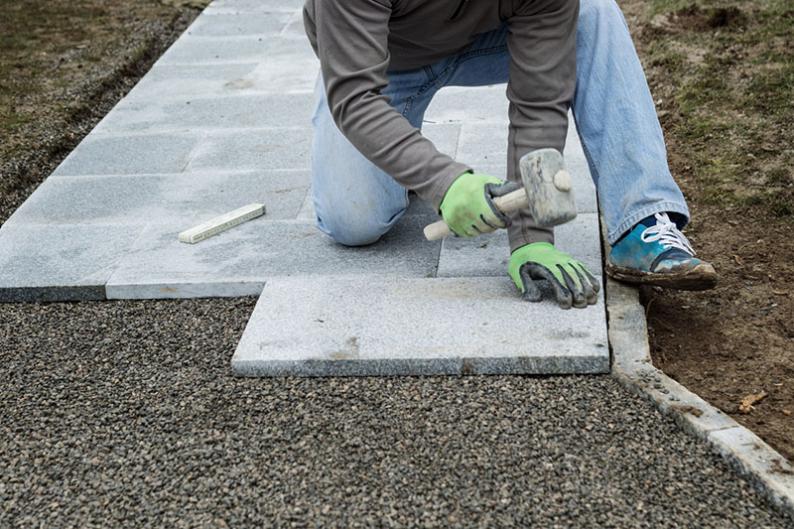 laying patio stones on walkway